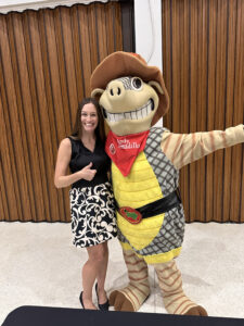 Nina Moser, Director of Development and Andy Armadillo, mascot of Texas Roadhouse Restaurants