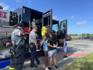 Children and families visit a Brevard County Fire Rescue fire truck and learn from firefighters during the Back-to-School Blast-Off Community Resource Fair in Cocoa, Florida.