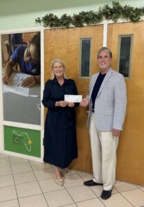 David W. Matte presents a ceremonial check establishing the David W. Matte Scholarship to Janice Kershaw, President and CEO of Brevard Schools Foundation. The scholarship will support graduating Brevard Public Schools seniors pursuing higher education at Florida public universities.