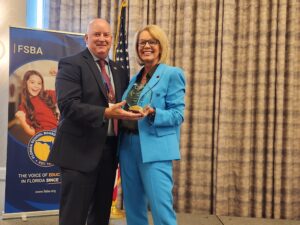 Dr. Mark Rendell, Superintendent of Brevard Public Schools, accepts the 2025 STAR Superintendent of the Year Award from Amity Schuyler, President and CEO of the Consortium of Florida Education Foundations.
